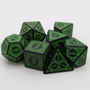 Set of green and black polyhedral dice on a white background